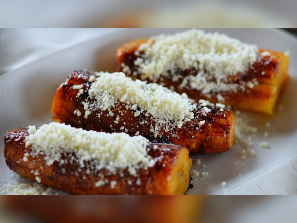 Mitades de plátano dulce en almíbar de canela con queso blanco rallado por encima